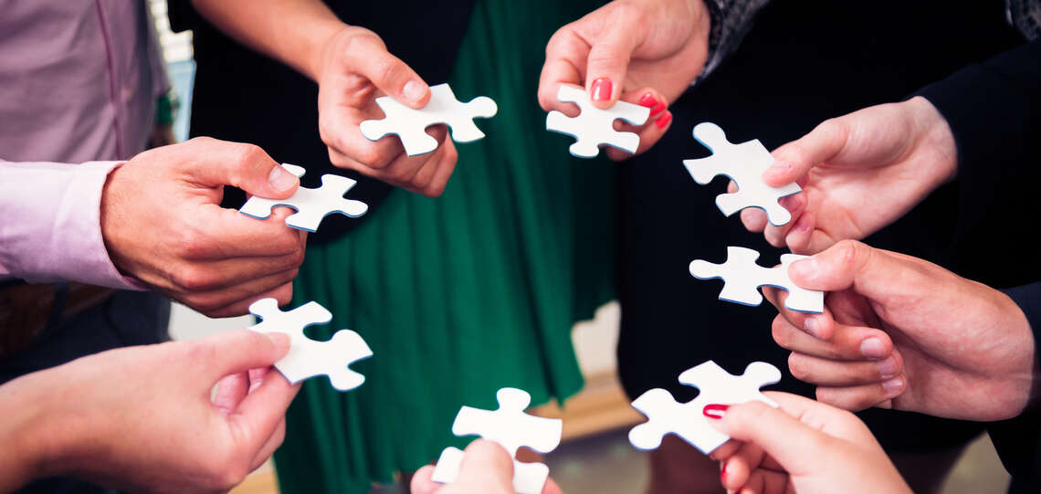 Hands with puzzle pieces.